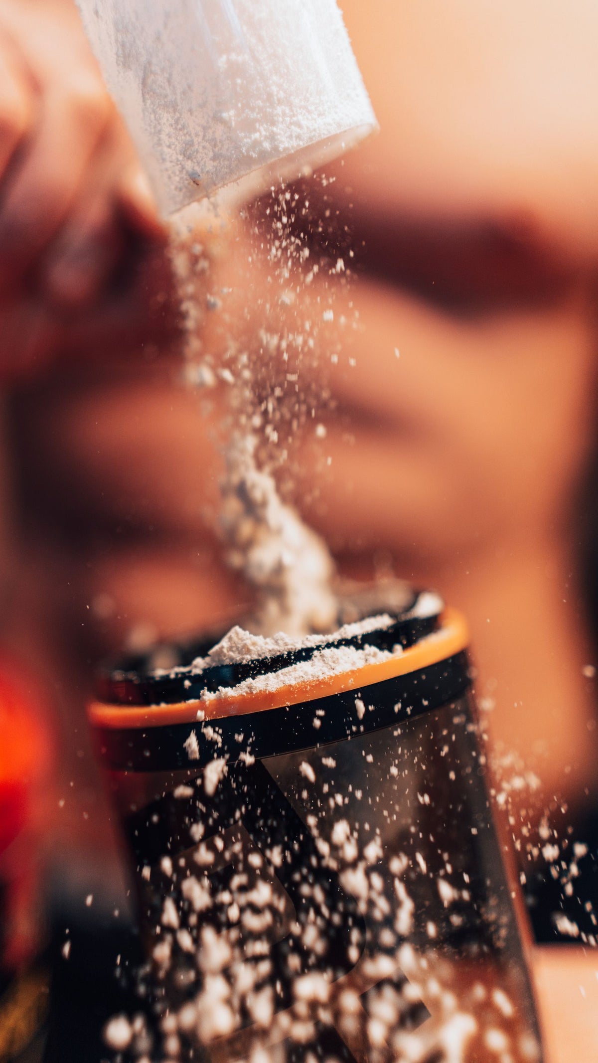Protein powder being added to a shaker