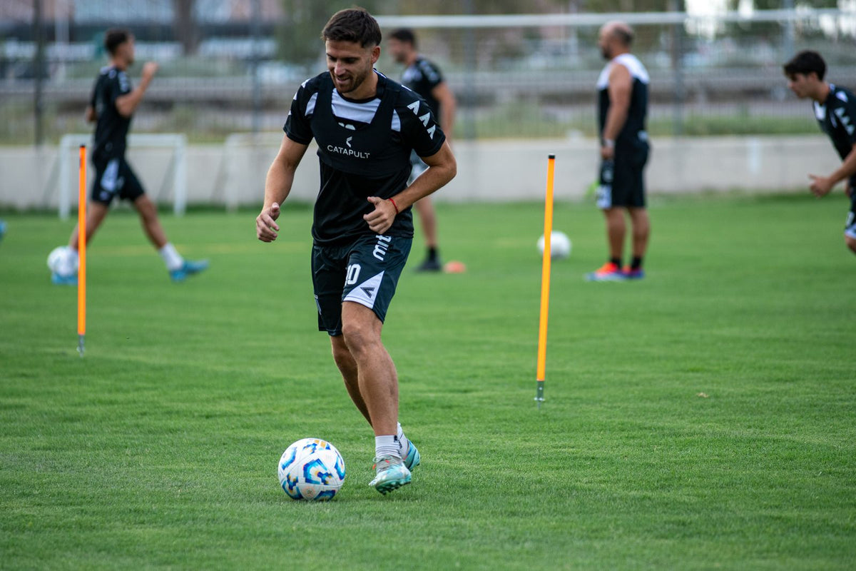 Soccer players training together on a grass field
