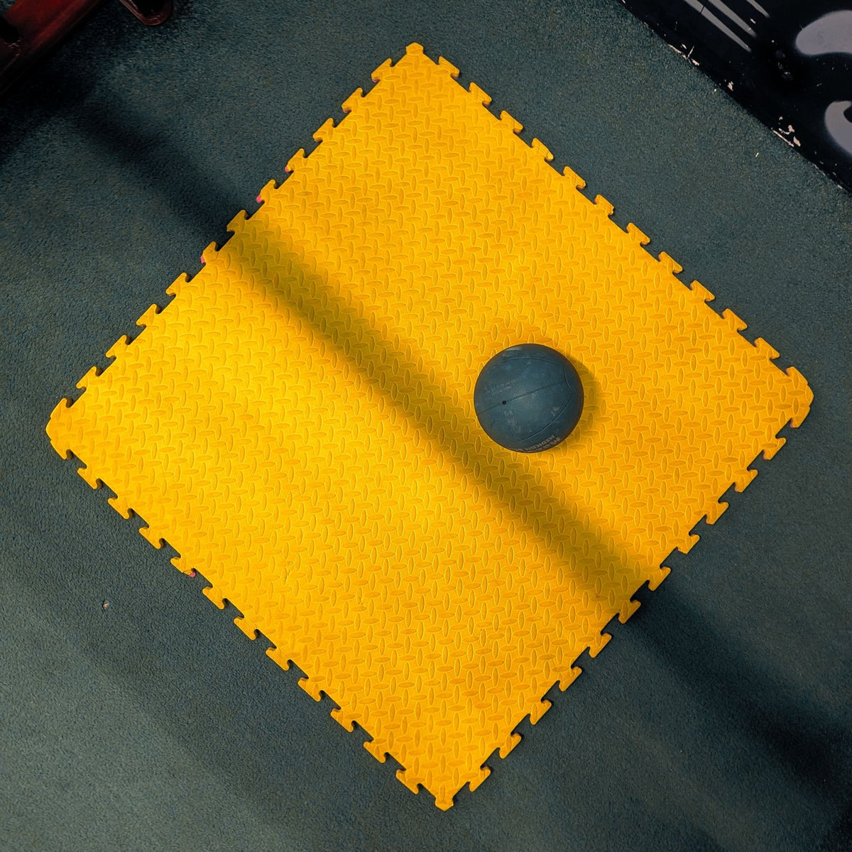 Medicine ball on yellow and black gym flooring