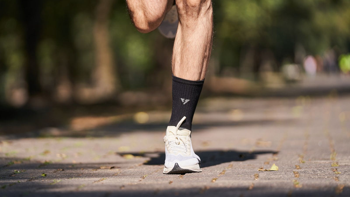 Runner's shoes and lower legs on a path outdoors