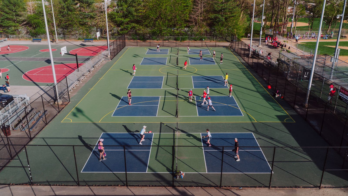 Players on outdoor pickleball courts viewed from above