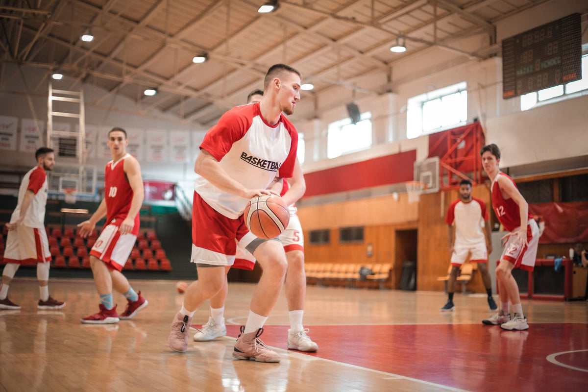 Basketball players practising on an indoor court