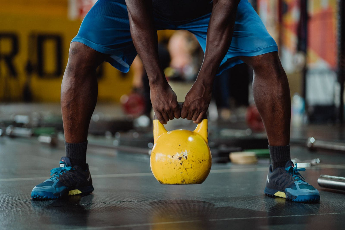 Athlete lifting a kettlebell in a gym