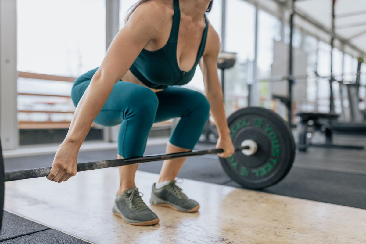 Woman lifting a barbell during gym training