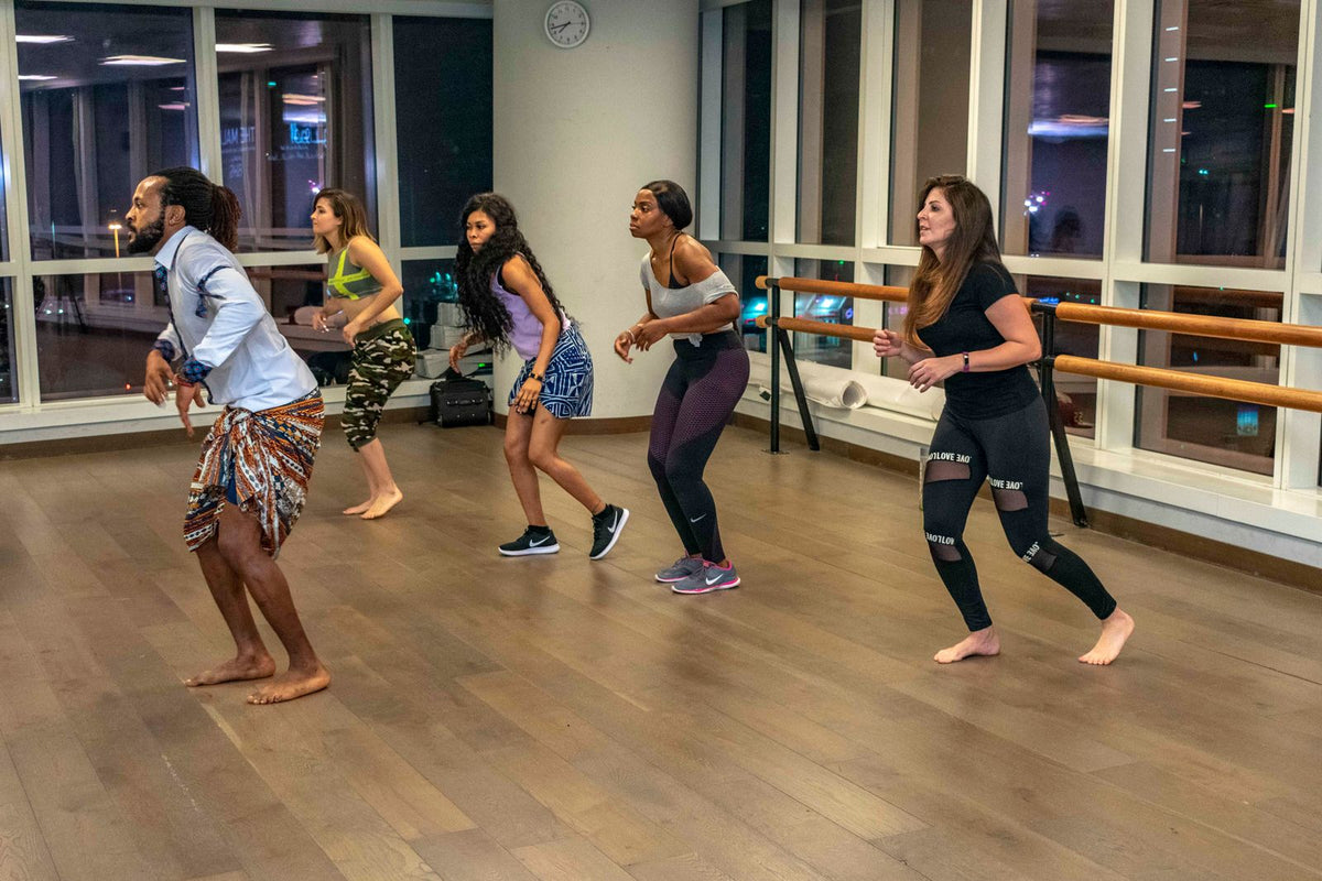 Adults taking part in a group dance fitness class