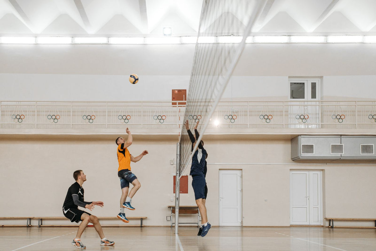 Players taking part in an indoor volleyball game