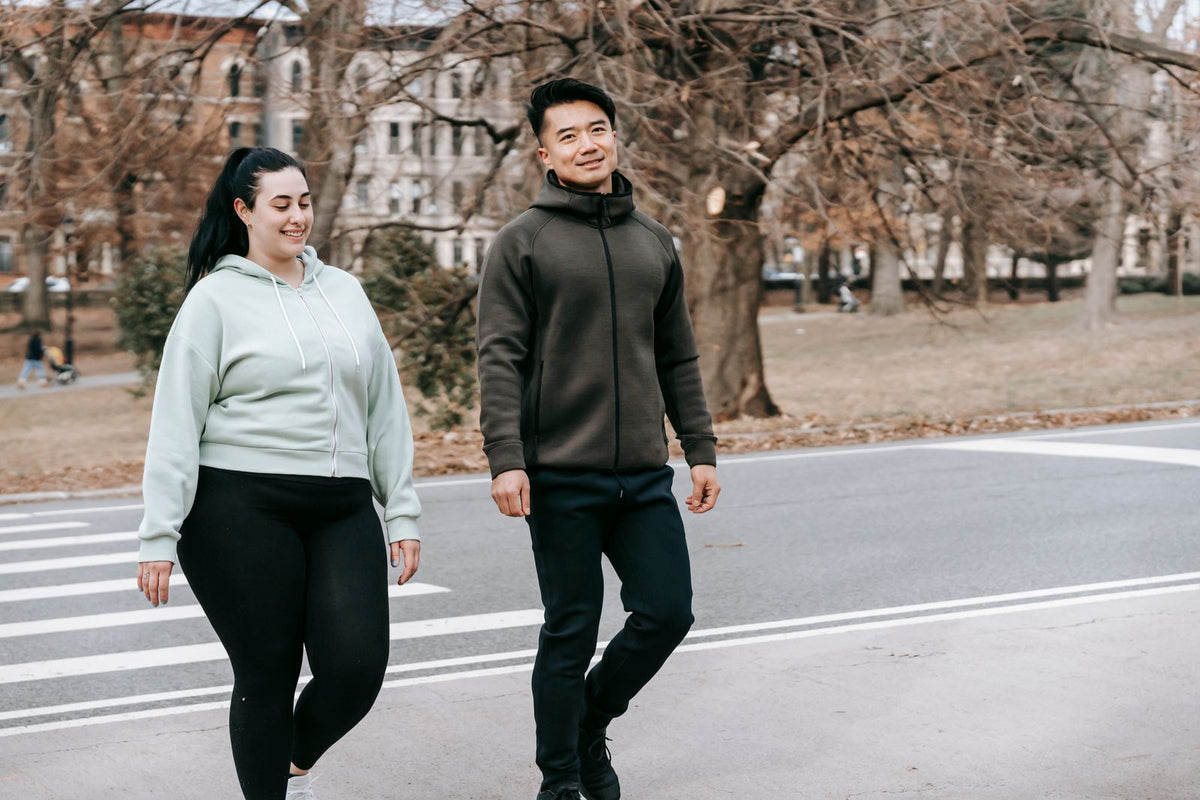 Two people walking outdoors after exercise
