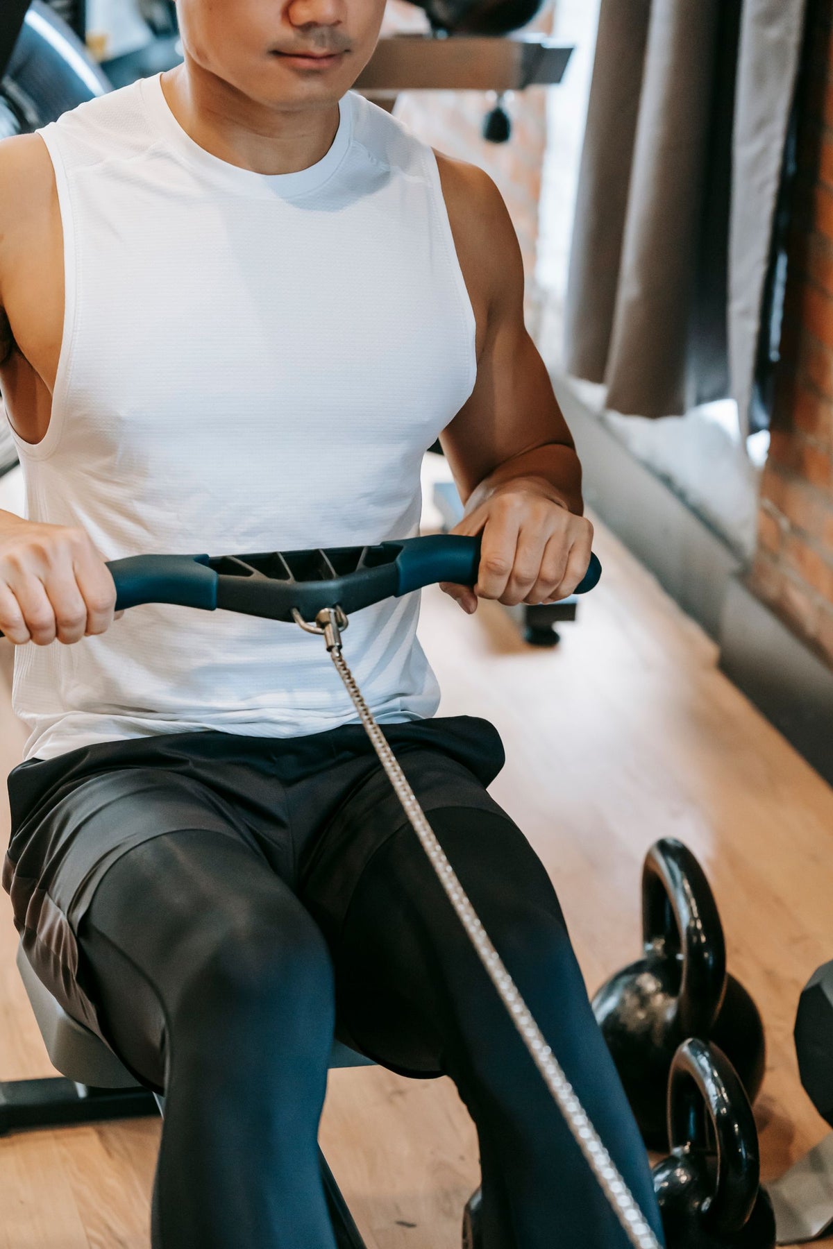 Athlete training on a rowing machine in a gym