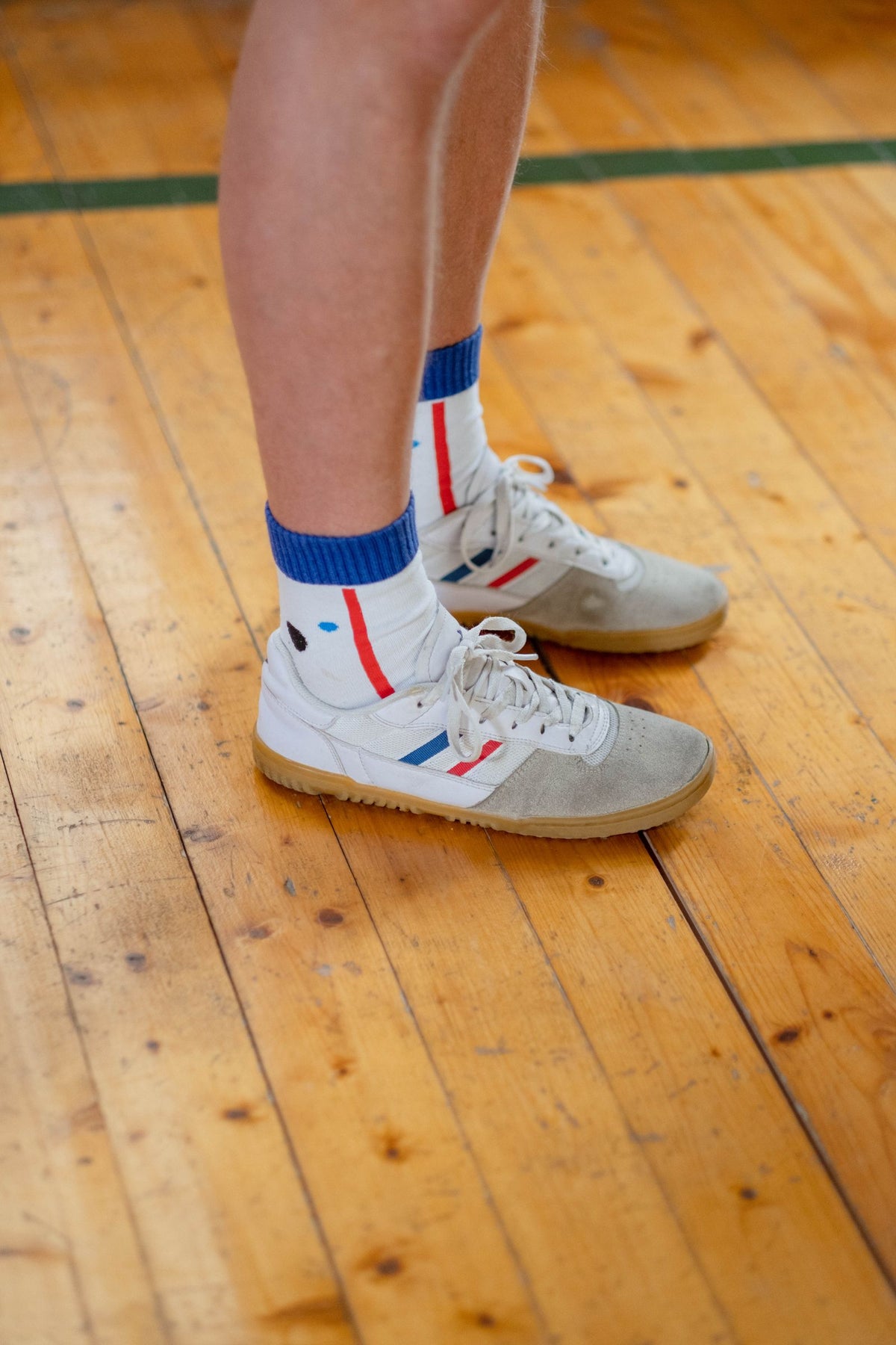 Sports socks and athletic shoes on a wooden floor