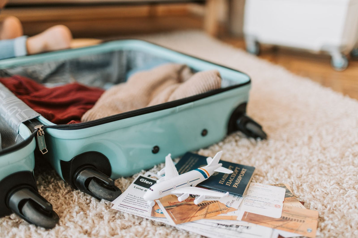 Open suitcase with travel documents and personal belongings