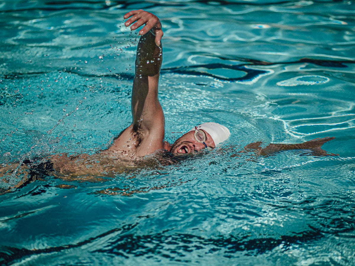 Swimmer practising freestyle in a swimming pool